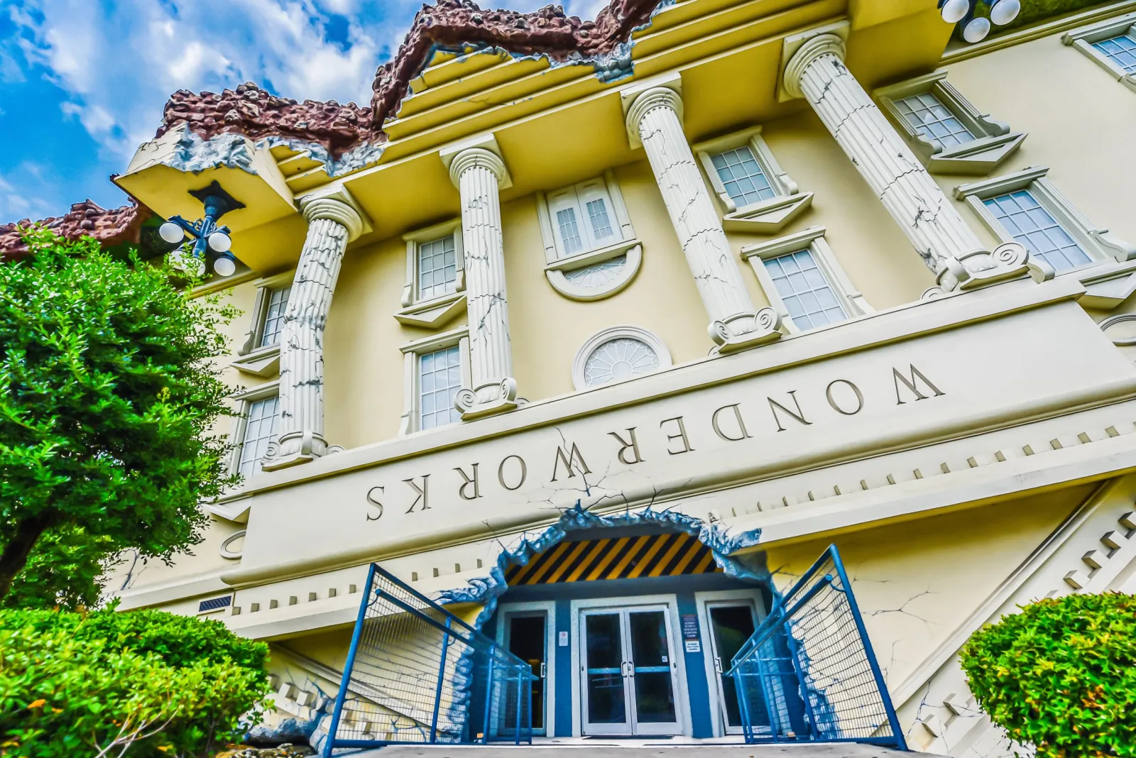 The upside-down WonderWorks building with inverted columns and lettering above a cracked entrance