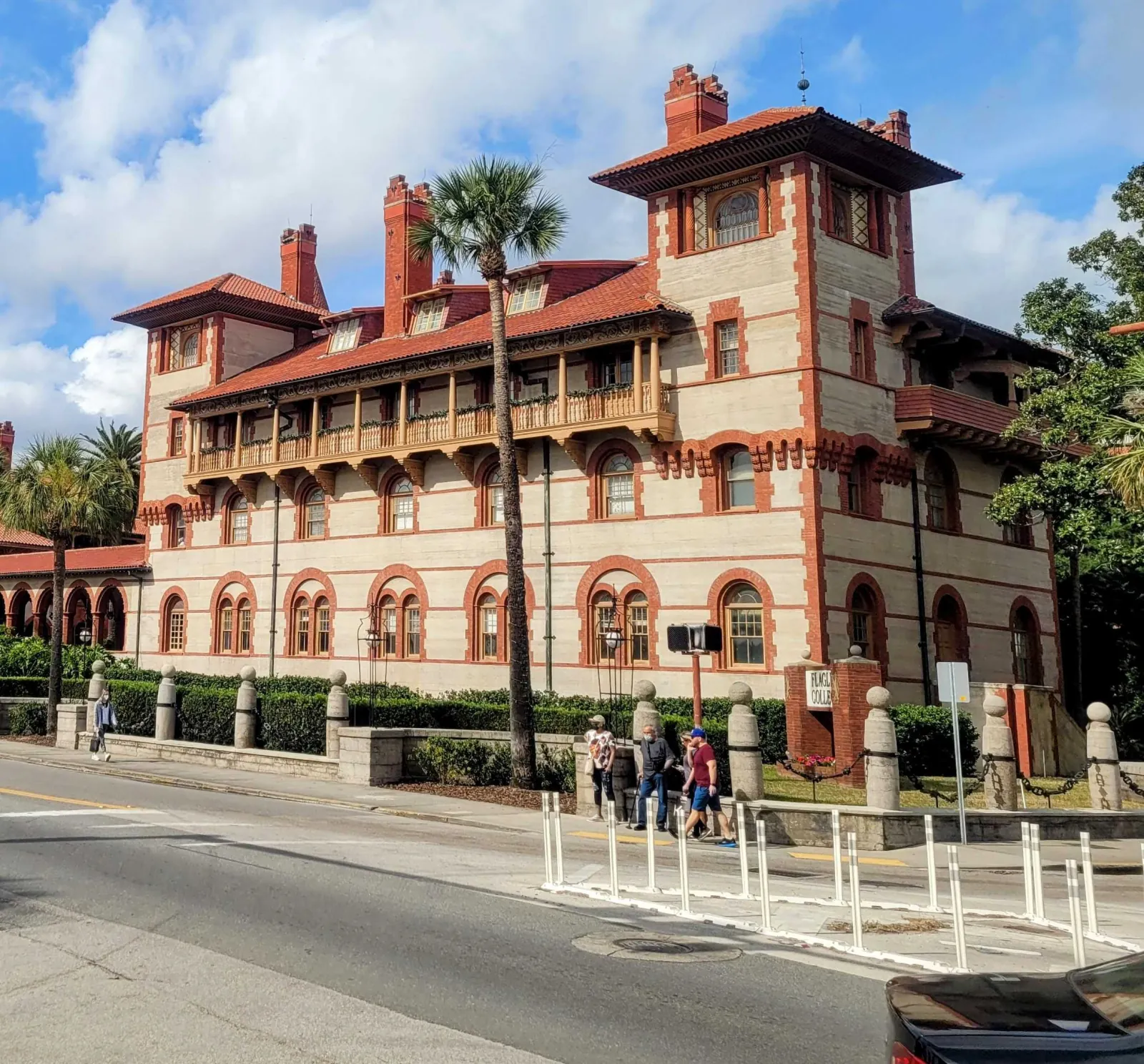 Red-trimmed Spanish Renaissance building of Flagler College with tile roofs and balconies