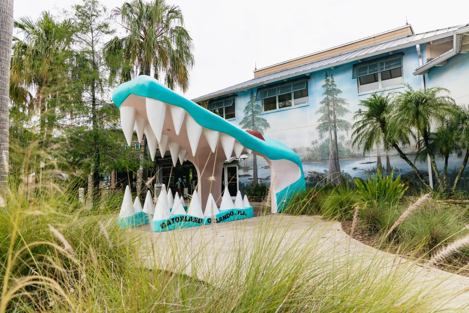 Giant turquoise alligator-jaw archway at the Gatorland entrance