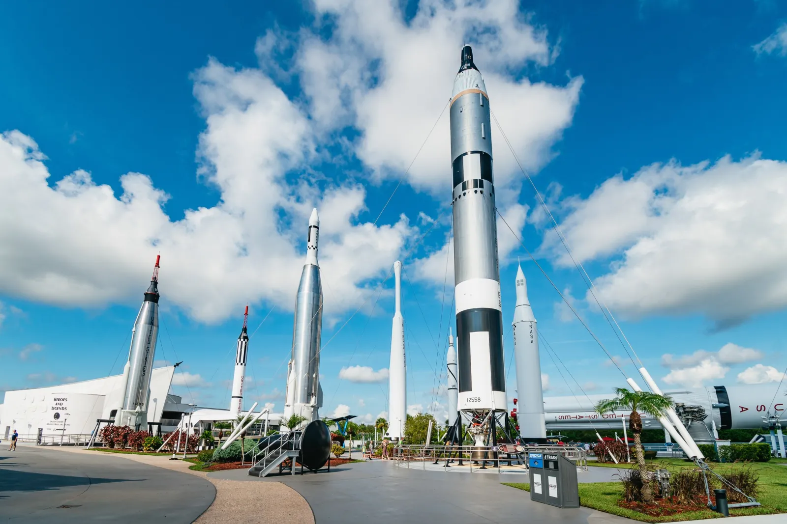 Rocket Garden at Kennedy Space Center under a blue sky, with historic Mercury and Gemini-era rockets standing upright