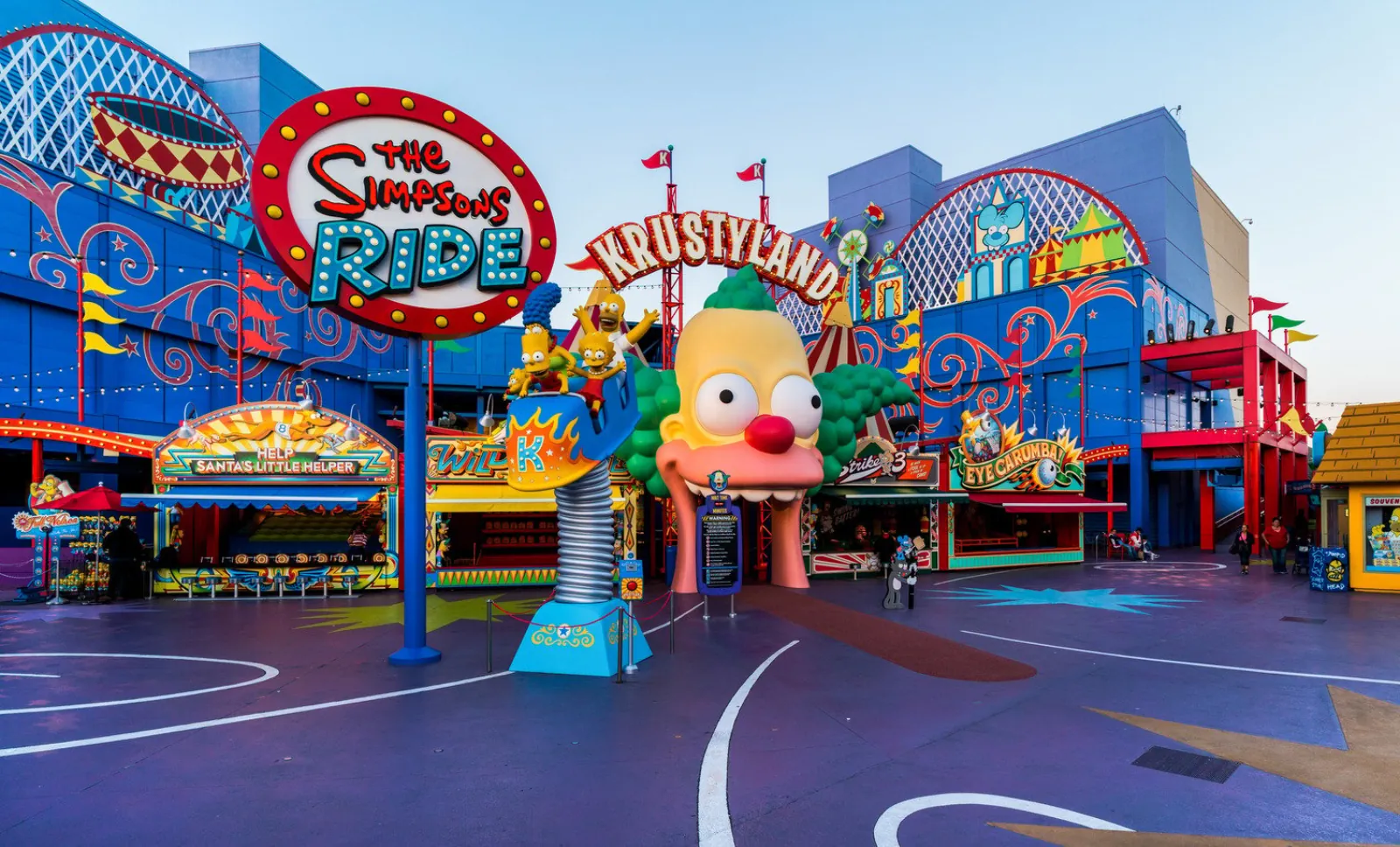 Colorful Krustyland entrance with a giant Krusty the Clown face and The Simpsons Ride sign