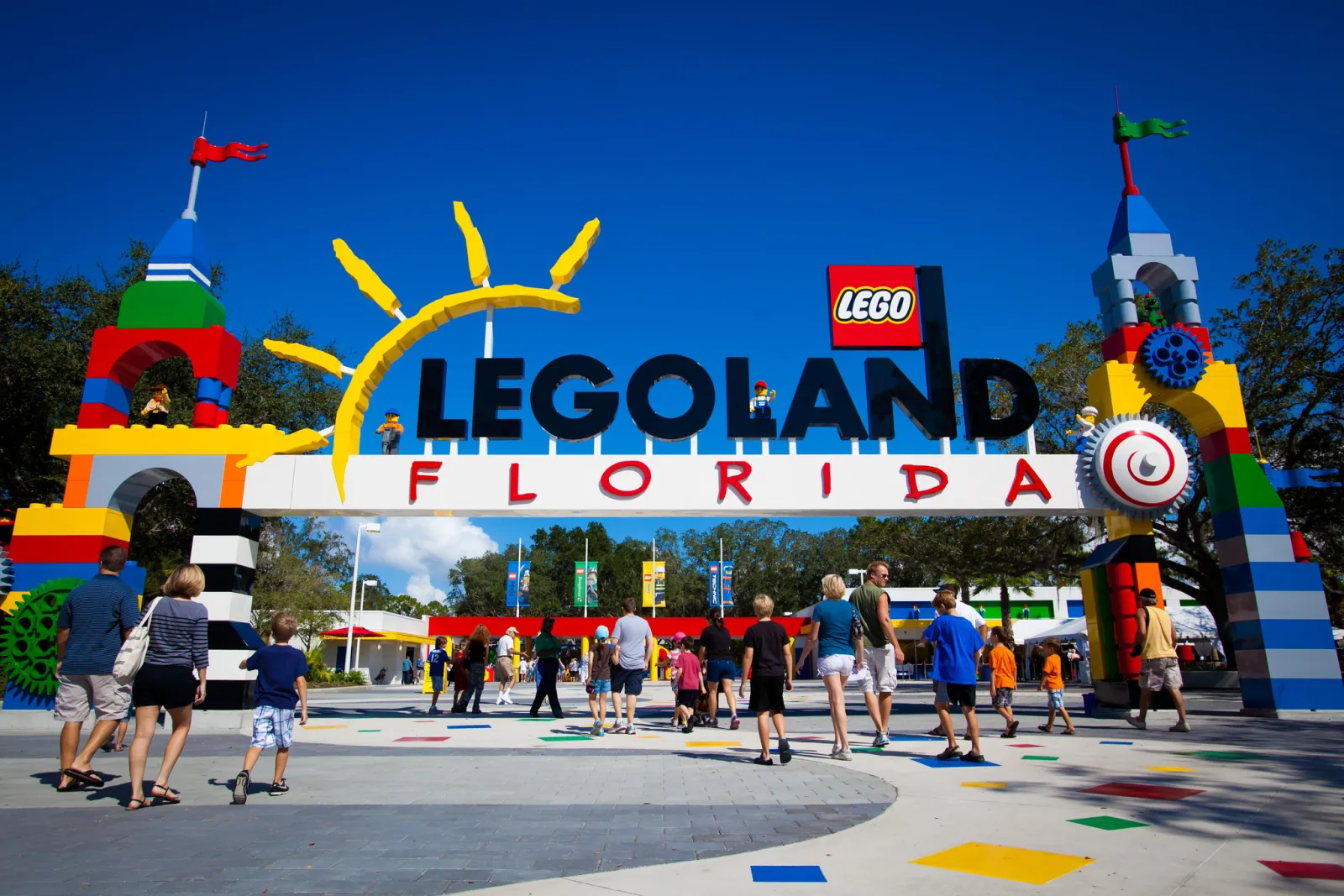 Families walking under the brick-built LEGOLAND Florida entrance arch